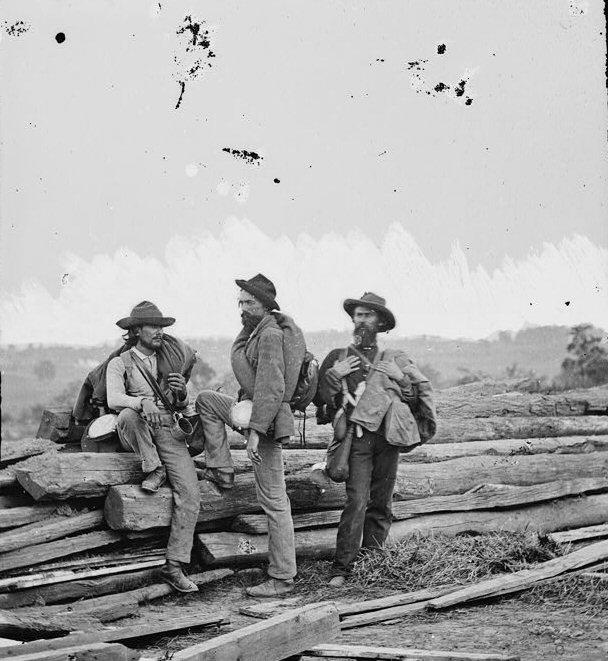 In this iconic photograph of Confederate Prisoners captured near Gettysburg, note the tin cup the man on the left carries.