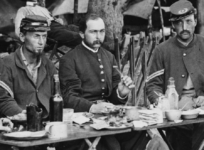 Here are some of the NCOs of Co. D, 93rd New York Infantry. This picture is chock full of interesting stuff. If you have a chance, download the full image at the LOC and give it a look. But for now, notice the size and types of cups on their table. 
