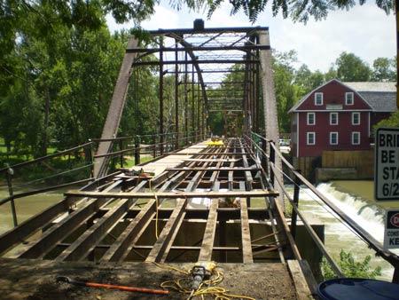 The bridge was stipped down to it's bare iron beams, and many of those were replaced. Then the entire iron structure received a coat of rust inhibitor, and two coats of paint, and all the timbers were replaced.  