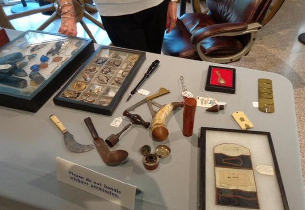 Some of Ann's jewelry, a Housewife, Traveling Inkwell, Button Polisher, and other artifacts.