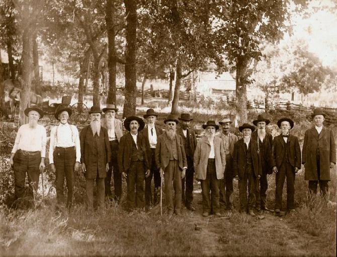 Survivors of Co. K, 34th Arkansas Infantry Regiment, CSA, ca. 1905-1916, on the old Prairie Grove, Arkansas, Battlefield.